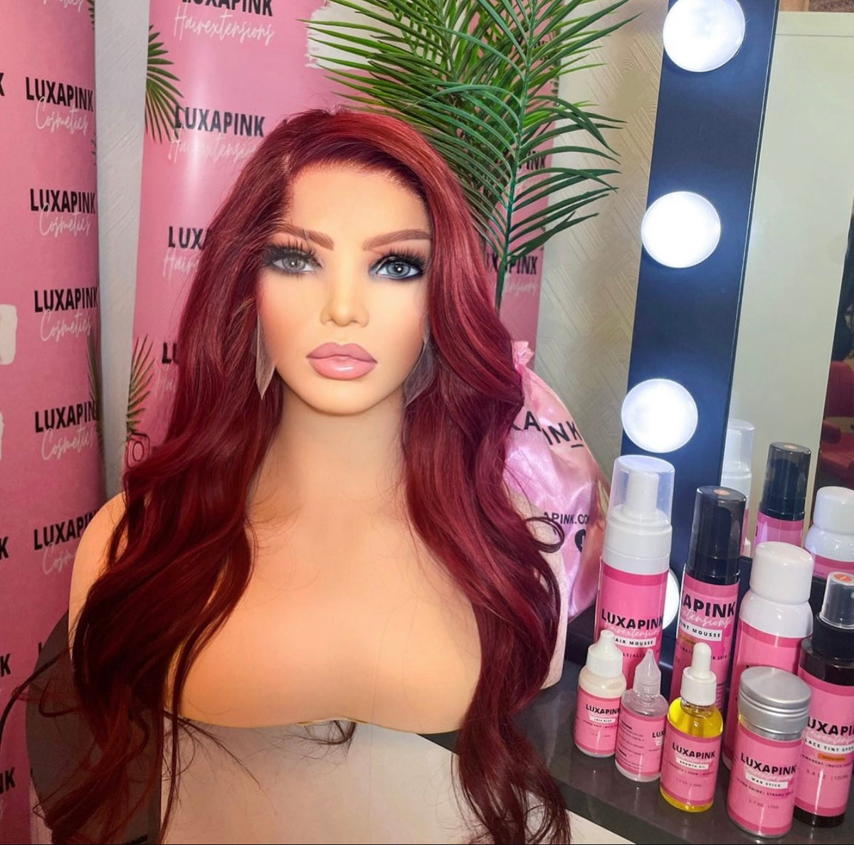a mannequin with red hair and makeup products