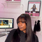 a woman with long hair in front of a computer