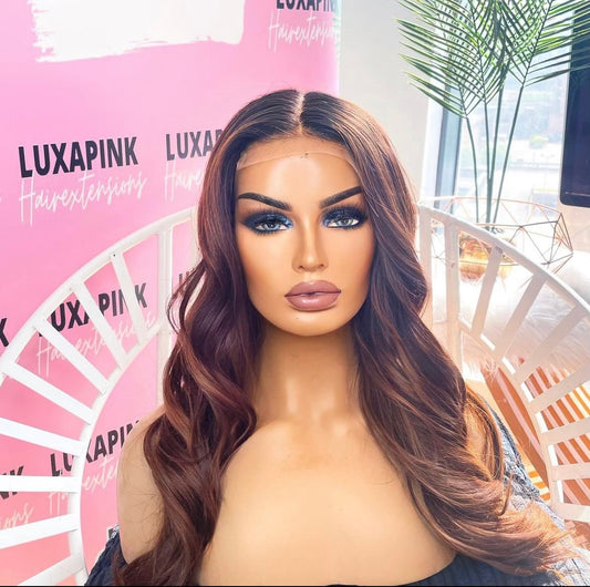 a mannequin with long hair sitting in a chair
