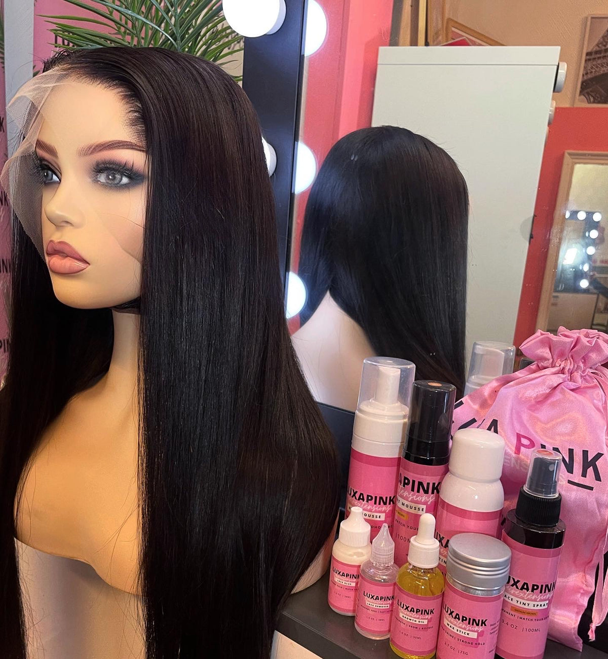 a mannequin with long hair and a pink bag