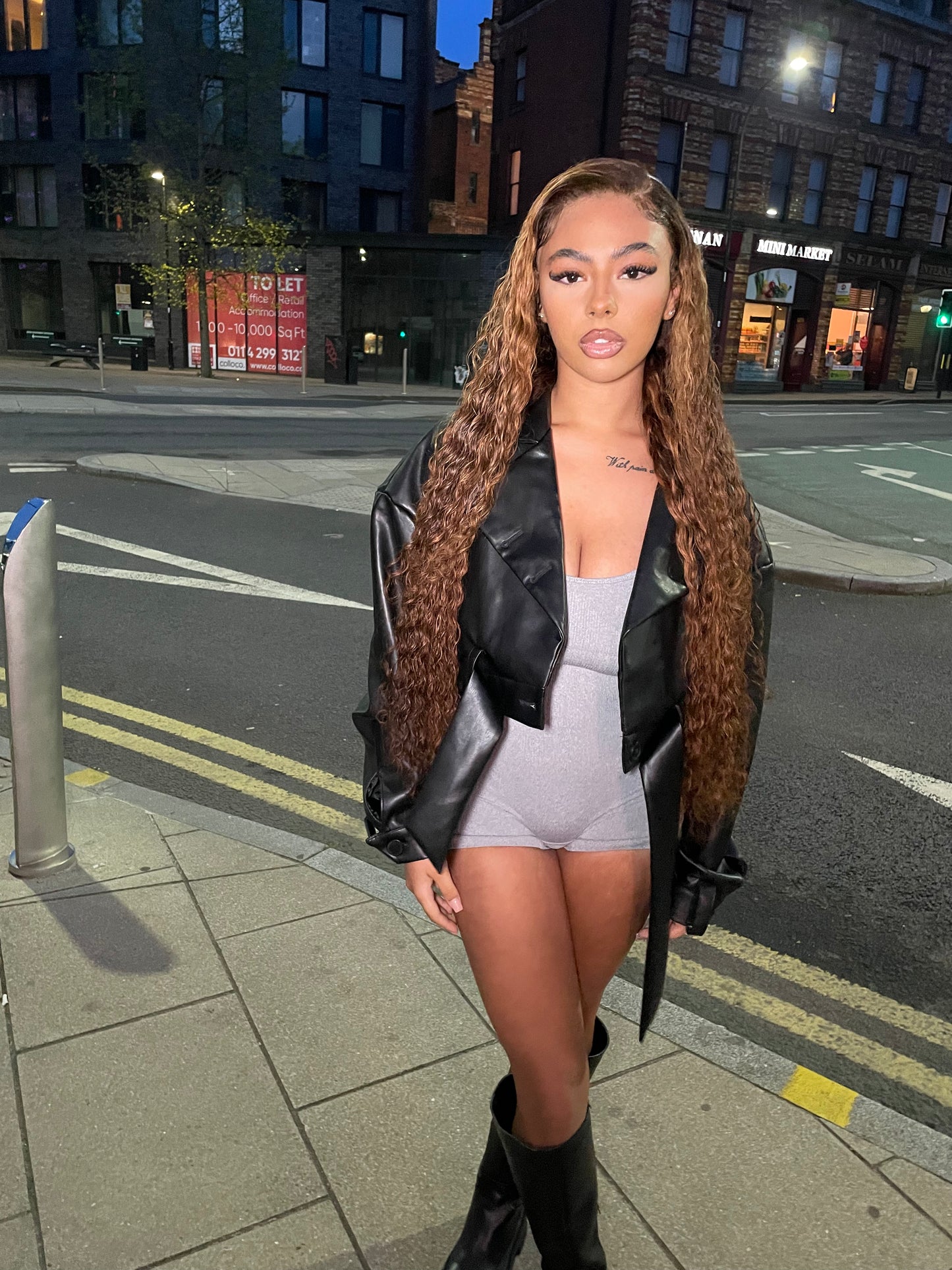 a woman standing on a sidewalk