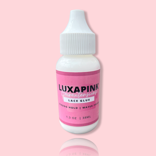 a white bottle with a pink label